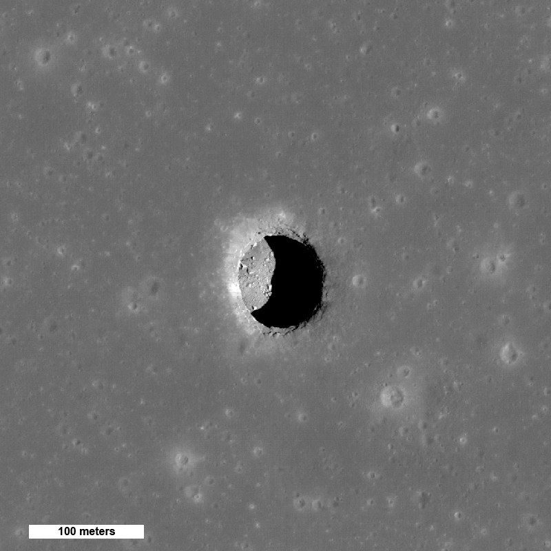 The Mare Tranquillitatis pit seen from above by the Lunar Reconnaissance Orbiter's narrow-angle camera. The pit is about 100 metres across; the 2024 radar study traced a cave conduit leading off it underground.