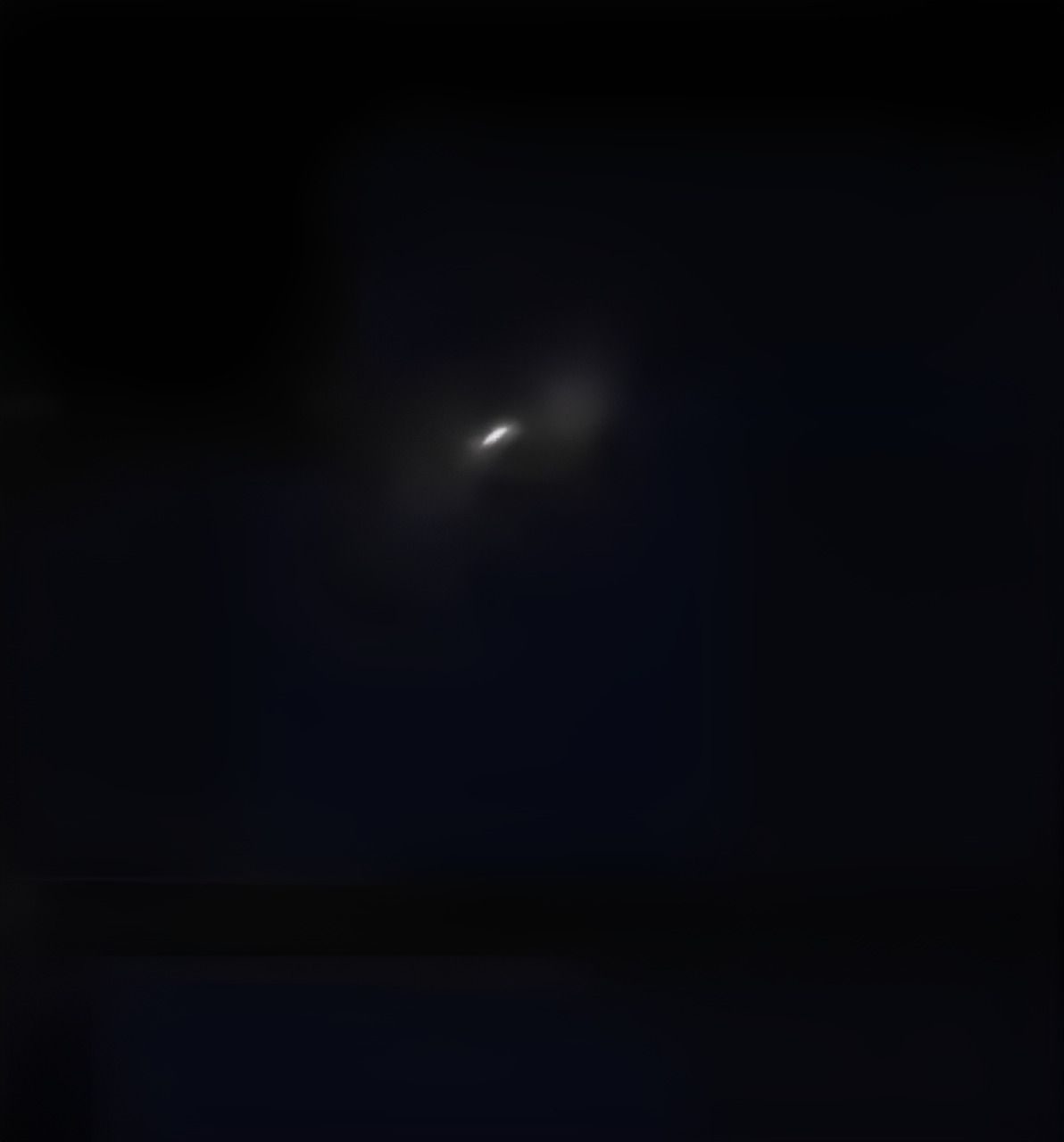 A frame from one of the viral videos: the light and its expanding glow.
