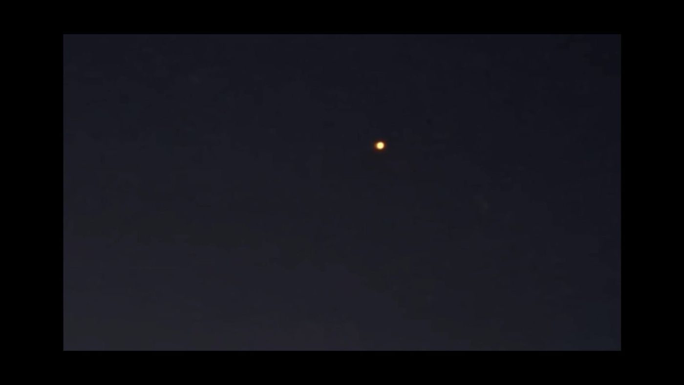 Still at 8 s from the official Borris video: single orange point of light. 2025-09-28 20:06 local, Borris camp, Denmark. Status: See video item. Note: See video item (WIF282 airliner identification).