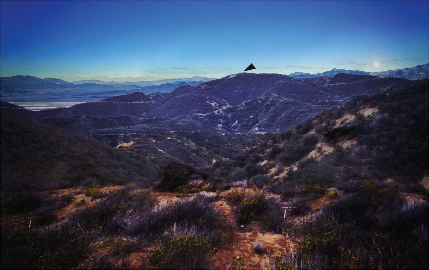 From the FBI FD-302 report (PURSUE Release 07): the ridge west of the observation post at dusk, with the black triangle drawn in where the agents saw it. A reconstruction made for the report, not a photograph of the object.