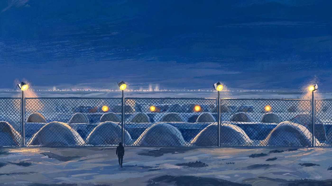 Nellis Area II at night: earth-covered weapons bunkers behind the fence, a lone guard, and amber orbs hovering silently above.
