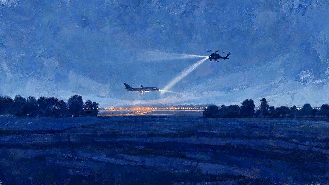 Nuremberg airport at night: an airliner on approach while a police helicopter searches the sky.