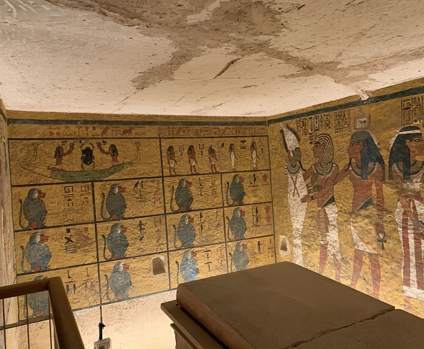 The burial chamber of Tutankhamun's tomb (KV62) with the sarcophagus in front. The painted north wall, on the right, is the wall Nicholas Reeves argued hides a sealed doorway; the west wall with its rows of baboons is at the back.