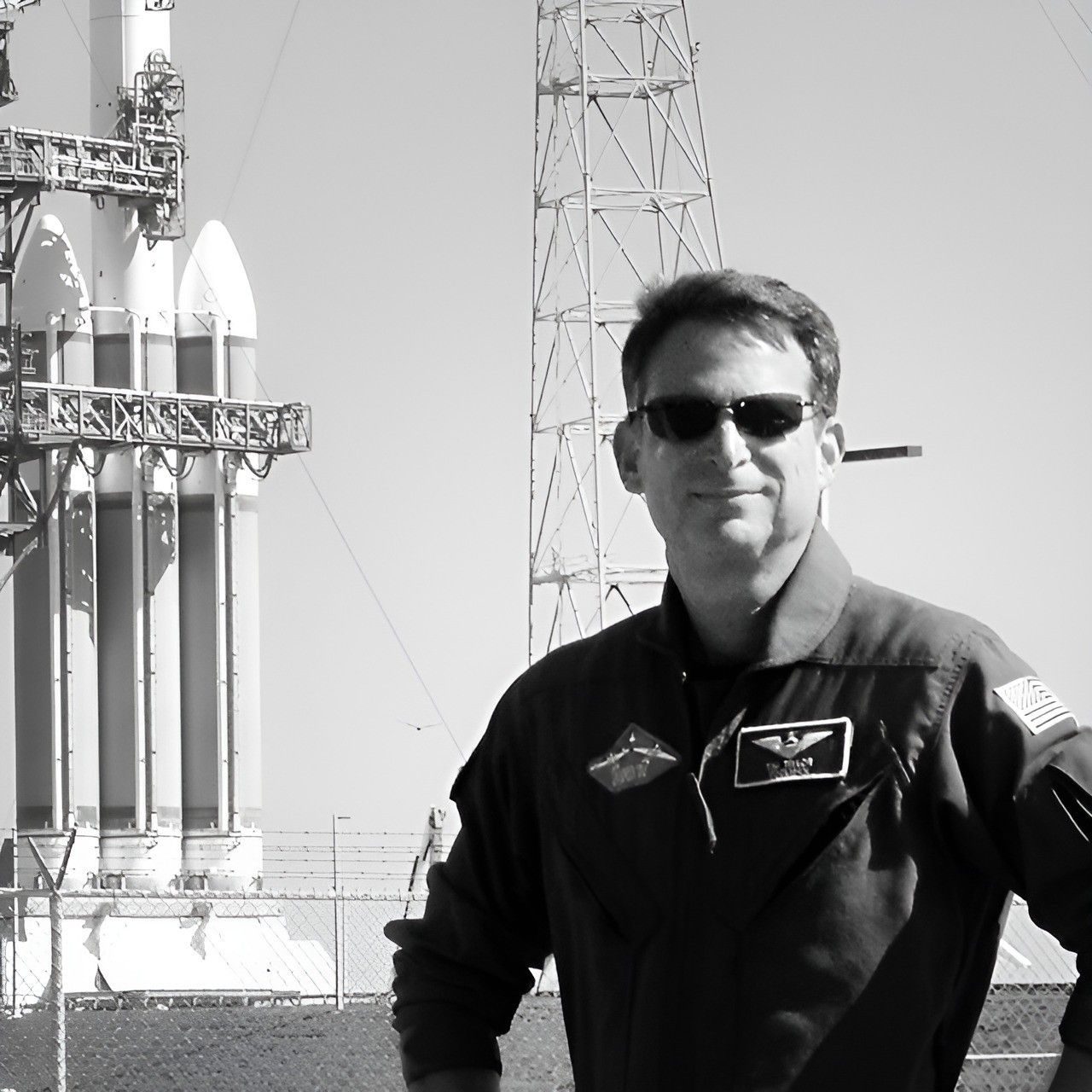 Tim Taylor at a launch pad, with a Delta IV Heavy behind him (VIVEX Biologics board photo).