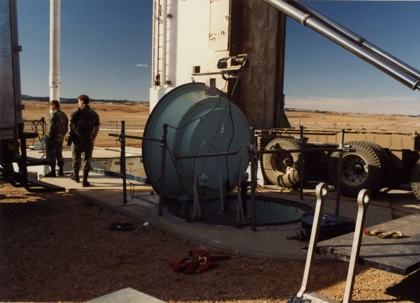 Context photo, not the incident site: two airmen beside the open personnel access hatch at Ellsworth launch facility K-09, with the transporter-erector behind them. Taken between 1975 and the early 1990s; exact date not recorded.