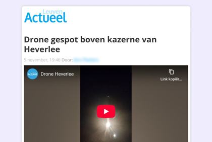 Screenshot of Leuven Actueel article "Drone gespot boven kazerne van Heverlee" with embedded video of a bright light. 2025-11-05 ~19:46 local, Military barracks, Heverlee (Leuven), Belgium. Status: VRT NWS Check groups it with the G16 police-helicopter explanation. Note: Identified as police helicopter by VRT.