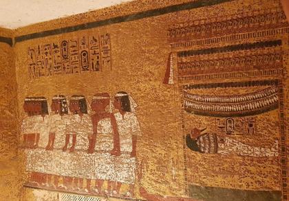 The funeral procession painted on the east wall of the KV62 burial chamber: men drag Tutankhamun's mummy on a sledge under a canopy.