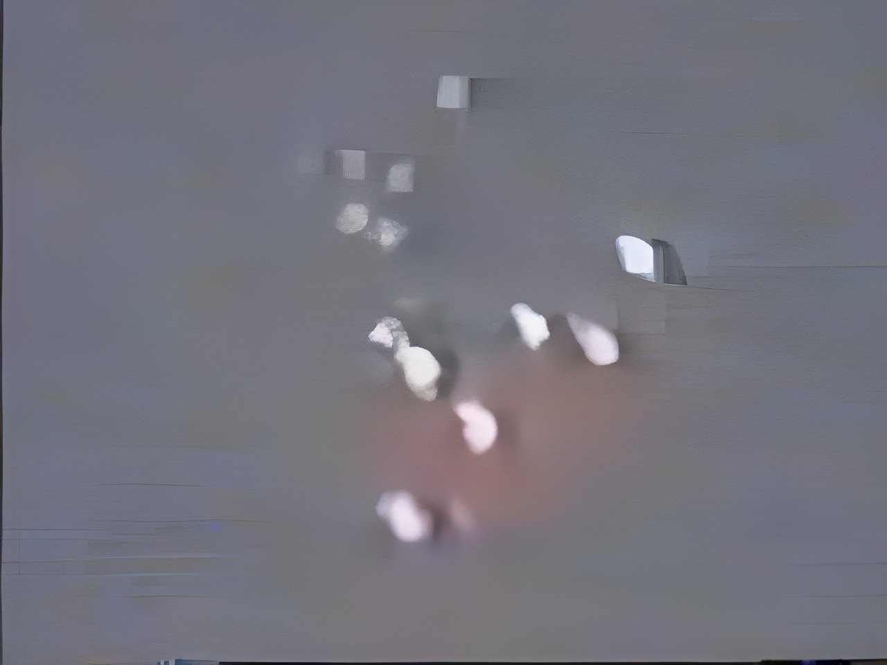 Video frame: two clusters of lights over the Baltic coast near Greifswald, 24 Aug 1990, from an amateur witness video as shown in an ARD documentary. Low-resolution (320x240 source, upscaled to 640x480). Military illumination flares have been proposed.